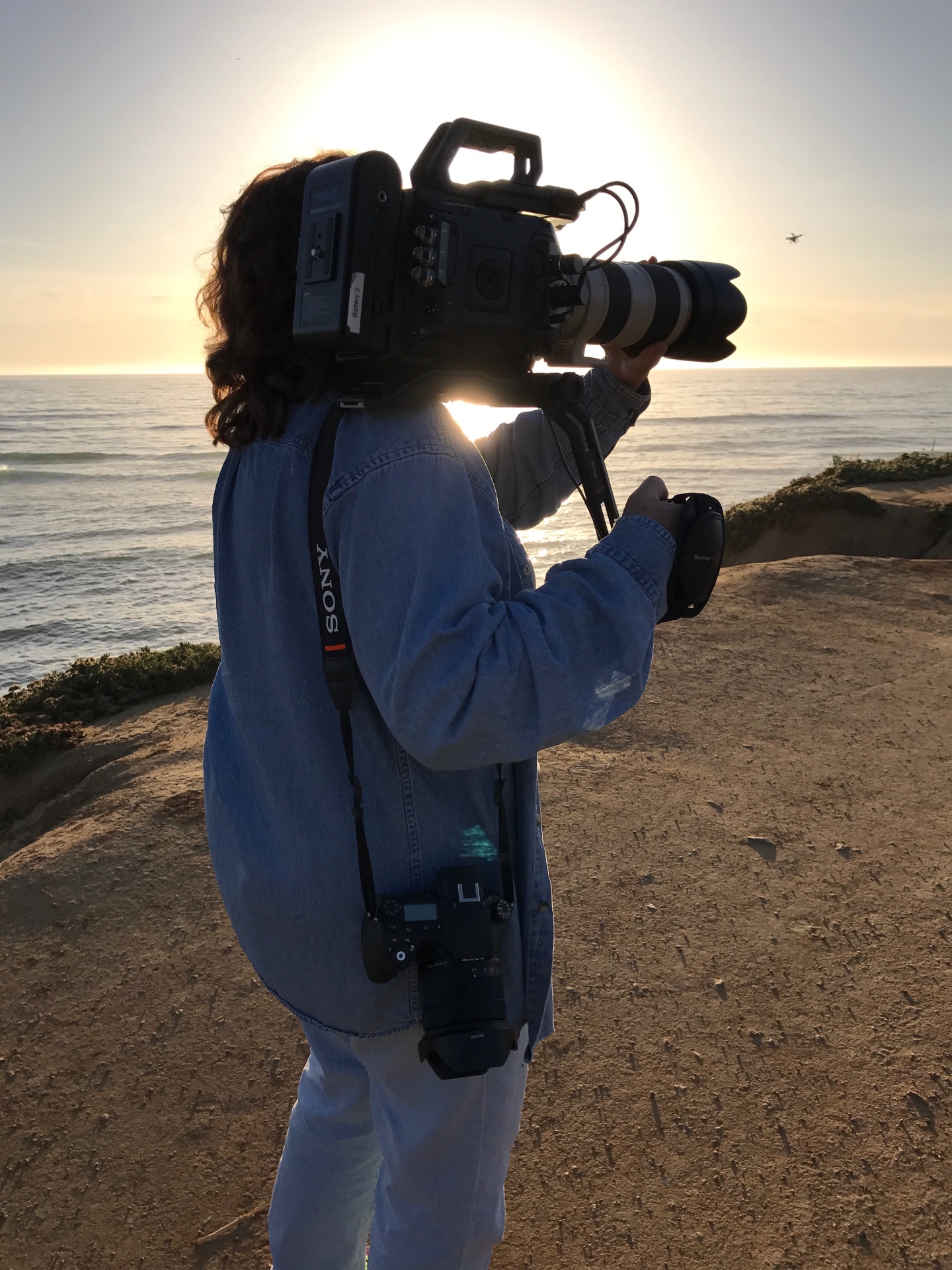 Cirina Catania shooting on location with a cinema camera at sunset
